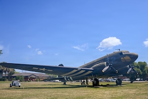 A photo of a static C-47 Skytrain sitting outside.