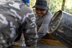 U.S. Army Staff Sgt. Somvang Xayphengsy, center, a recovery NCO, assigned to a Defense POW/MIA Accounting Agency recovery team, wet screens during a recovery mission in Laos, March 16 2026.