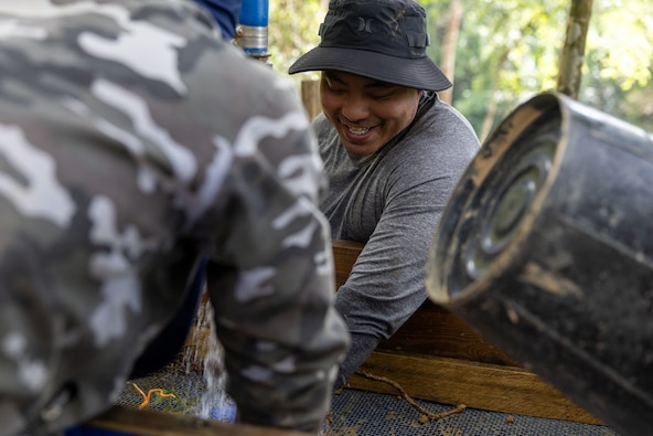 U.S. Army Staff Sgt. Somvang Xayphengsy, center, a recovery NCO, assigned to a Defense POW/MIA Accounting Agency recovery team, wet screens during a recovery mission in Laos, March 16 2026.