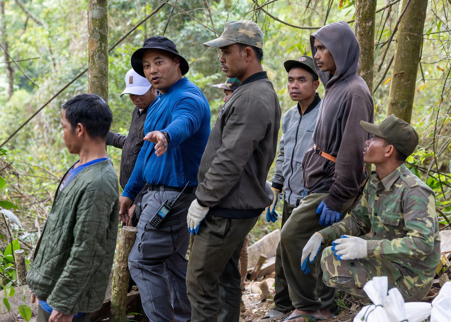 U.S. Army Staff Sgt. Somvang Xayphengsy, center, a recovery NCO, assigned to a Defense POW/MIA Accounting Agency recovery team, helps translate during a recovery mission in Laos, March 8 2026.