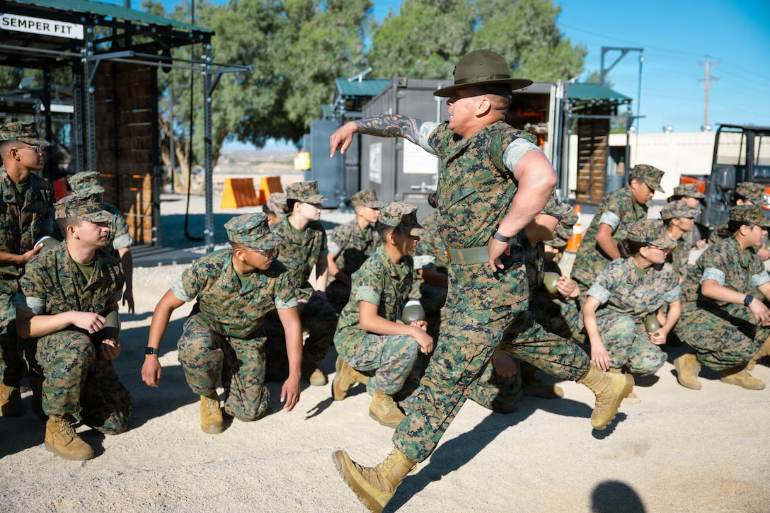 U.S. Marine Corps Staff Sgt. Ricky Torres, drill instructor with Lima Company, 3rd Recruit Training Battalion, interacts with students from the Morongo Unified School District at Marine Corps Air Ground Combat Center, Twentynine Palms, California, March 12, 2026. Military career day provided MUSD students a chance to explore possible military career paths and allowed them to speak with recruiters from each military branch. (U.S. Marine Corps photo by Lance Cpl. Gracelyn Hanson)