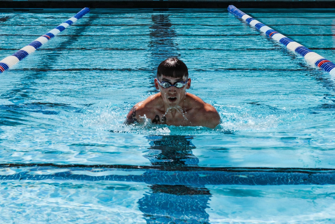 U.S. Marine Corps Gunnery Sgt. James Terrazas, an instructor with Marine Corps Logistics Operations Group, swims during the Fittest Instructor Competition in the training tank at Marine Corps Air Ground Combat Center, Twentynine Palms, California, March 25, 2026. The Marine Air Ground Task Force Training Command hosted this event to identify and select the most qualified instructor to represent the command at the annual Fittest Instructor Competition in Quantico, VA. (U.S. Marine Corps photo by Lance Cpl. Lainey Brummett)