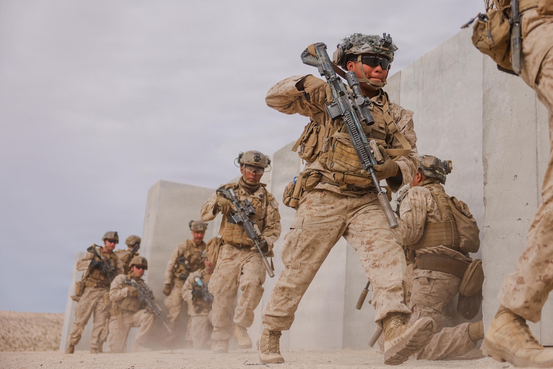 U.S. Marine Corps Cpl. Alexander PalafoxCayetano, a New York native, a transmission system operator with 1st Battalion, 2nd Marine Regiment, 2nd Marine Division, enters a building during urban lane training as part of service level training exercise 3-26 at Marine Corps Air Ground Combat Center, Twentynine Palms, California, April 6, 2026. Service level training exercise assesses Marine Air Ground Task Forces abilities to plan, coordinate and execute large-scale operations by integrating command and control, maneuver, sustainment and live-fire events in realistic training environments.   (U.S. Marine Corps photo by Lance Cpl. Parker Peichel)