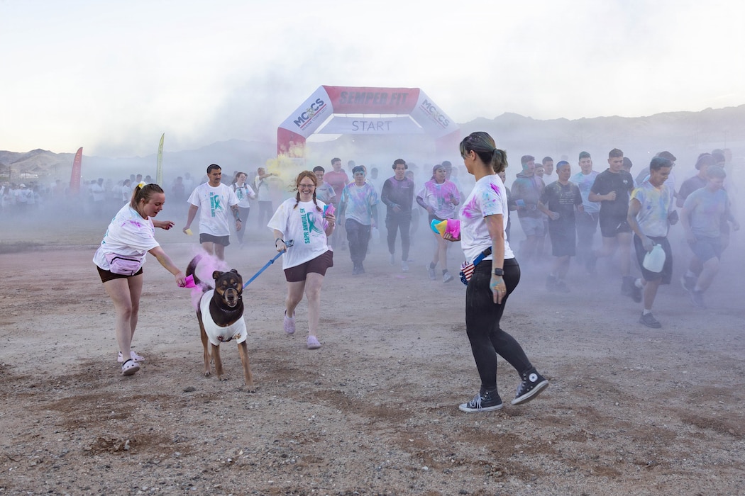 Participants in the Colorful Consent 5K run throw colored chalk at Del Valle Field, Marine Corps Air Ground Combat Center, Twentynine Palms, California, April 10, 2026. In recognition of Sexual Assault Awareness and Prevention Month, the Combat Center hosted a 5K color run, organized by Semper Fit, to promote education and support for sexual assault prevention. (U.S. Marine Corps photo Lance Cpl. Cody Fitzgerald)