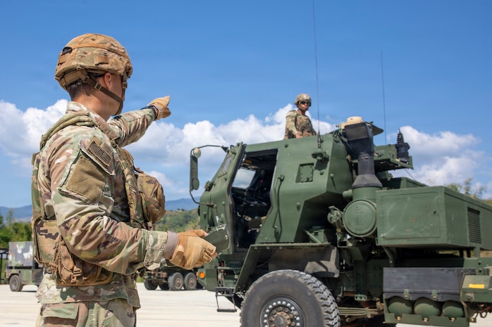 U.S. Army Sgt. Ian Jones, a multiple launch rocket system/high mobility launch rocket system crewmember assigned to 2nd Battalion, 11th Long Range Fires Battalion, signals to U.S. Army Spc. Ezekiel Heilig, a multiple launch rocket system/high mobility launch rocket system crewmember assigned to 2nd Battalion, 11th Long Range Fires Battalion, to check the gunner display unit on a HIMARS at Canantong, Laur, Neuva Ecija, Apr. 15, 2026.