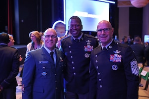 (Center) U.S. Space Force Chief Master Sgt. Jacob Simmons, command senior enlisted leader for U.S. Space Command, poses for a photo with Royal Canadian Air Force Chief Warrant Officer Jamie Marshall, 3 Canadian Space Division CWO, and Chief Master Sgt. John Bentivegna, the highest enlisted leader of the U.S. Space Force, at the 41st Space Symposium in Colorado Springs, Colorado, April 14, 2026. Simmons and Bentivegna participated in a “Perspectives on Partnership” panel at the symposium, highlighting the importance of partnership, innovation and industry collaboration to build a skilled, resilient space workforce and strengthen multinational operations.