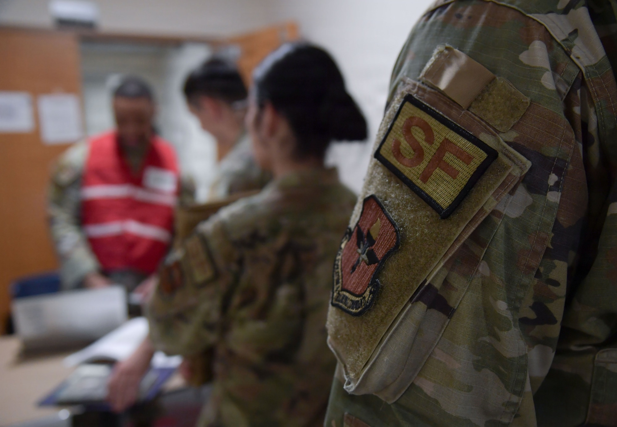 a close up photo shows a patch on an OCP sleeve reading "SF"