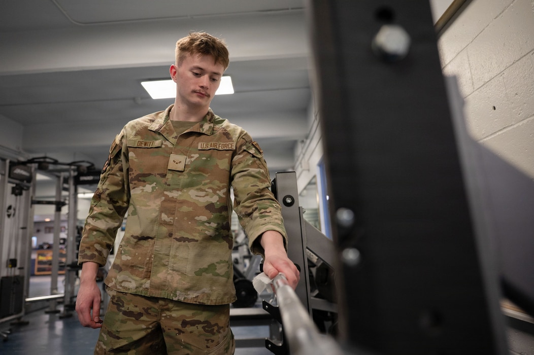 U.S. Air Force Airman 1st Class Emery Dewitt, 354th Force Support Squadron fitness journeyman, wipes down a barbell at Eielson Air Force Base, Alaska, March 5, 2026.