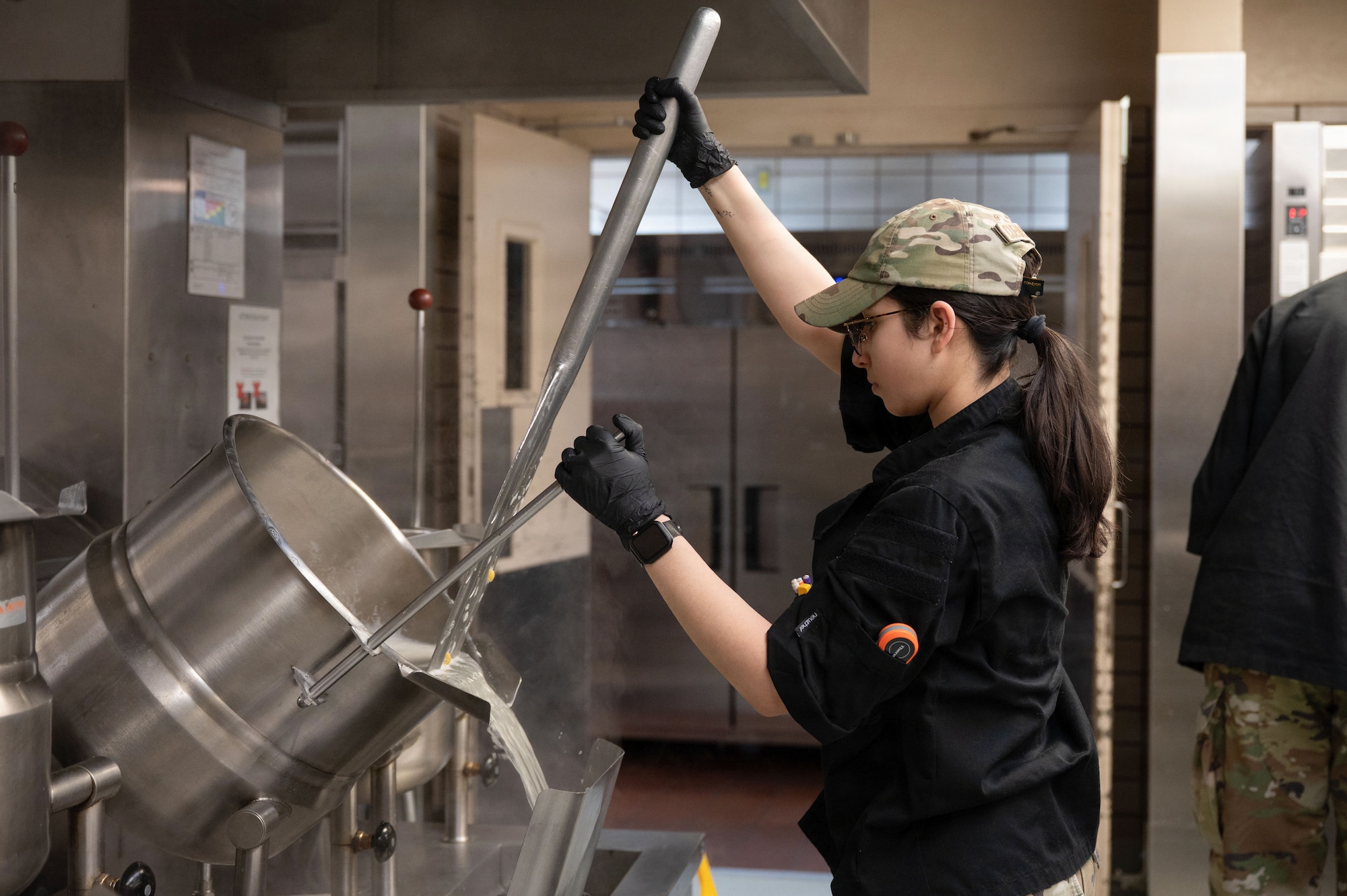 U.S. Air Force Senior Airman Bailey Cuevas-Gluzman, 354th Force Support Squadron food service journeyman, empties water from a pot at Eielson Air Force Base, Alaska, March 31, 2026.