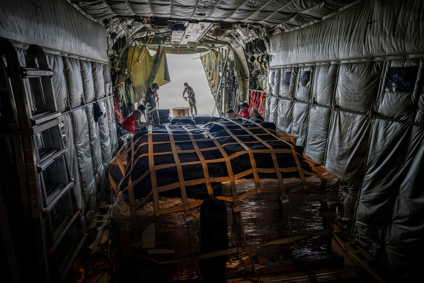 U.S. Coast Guardsmen assigned to a Coast Guard Air Station Barbers Point HC-130 Hercules airplane crew load equipment and supplies onto the airplane at the Antonio B. Won Pat International Airport in Tamuning, Guam, April 17, 2026. Coast Guard aircrews transported personnel with FEMA, the U.S. Army Corps of Engineers, the Department of Public Health and Social Services, and the Department of War to Saipan in support of recovery efforts following Typhoon Sinlaku. (U.S. Coast Guard photo by Chief Petty Officer Corinne Zilnicki)