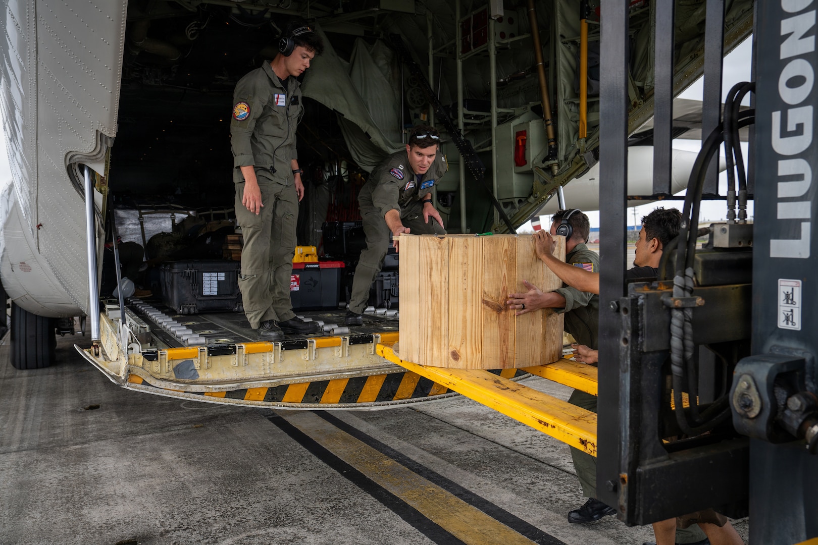 U.S. Coast Guardsmen assigned to a Coast Guard Air Station Barbers Point HC-130 Hercules airplane crew load equipment and supplies onto the airplane at the Antonio B. Won Pat International Airport in Tumining, Guam, April 17, 2026. Coast Guard transported personnel with FEMA, the U.S. Army Corps of Engineers, the Department of Public Health and Social Services, and the Department of War to Saipan in support of recovery efforts following Typhoon Sinlaku. (U.S. Coast Guard photo by Chief Petty Officer Corinne Zilnicki)