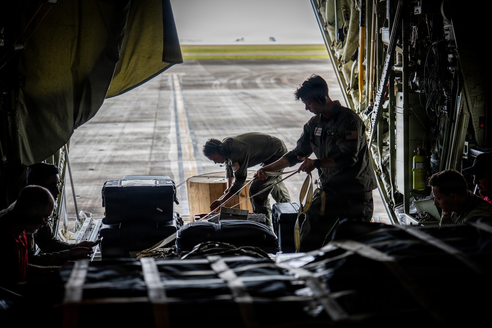 U.S. Coast Guard Petty Officer 2nd Class Chaz Russell and Petty Officer 3rd Class Antony Stark, aviation maintenance technicians assigned to Coast Guard Air Station Barbers Point in Kapolei, Hawaii, secure equipment and supplies on board an HC-130 Hercules airplane at the Antonio B. Won Pat International Airport in Tamuning, Guam, April 17, 2026. Coast Guard transported personnel with FEMA, the U.S. Army Corps of Engineers, the Department of Public Health and Social Services, and the Department of War to Saipan in support of recovery efforts following Typhoon Sinlaku. (U.S. Coast Guard photo by Chief Petty Officer Corinne Zilnicki)
