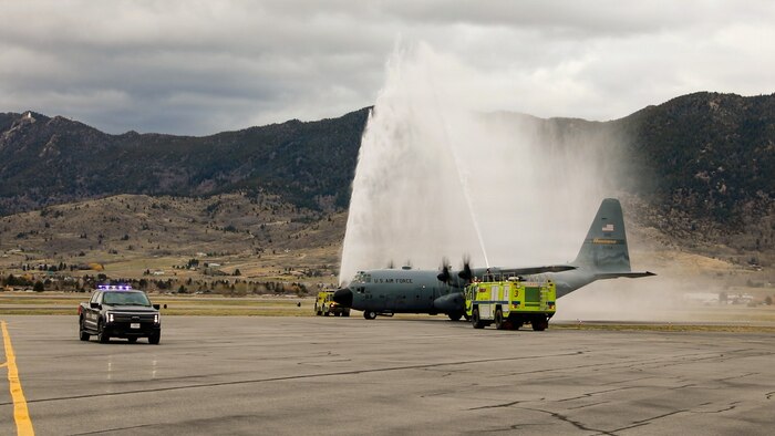 First responders from the Butte-Silver Bow Police and Fire departments render honors during a water salute.