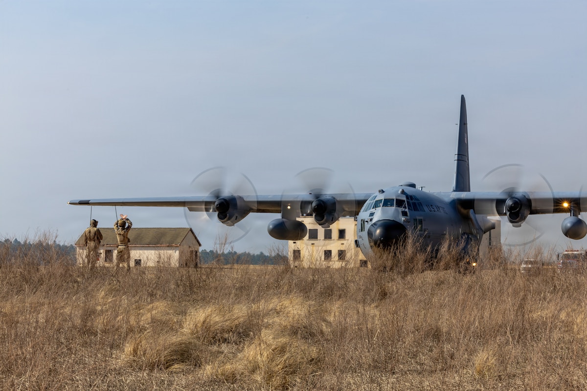 U.S. Air Force Tech. Sgt. Ethan O. Culliton, 352nd Special Warfare Training Squadron landing zone safety officer, left, oversee a Dutch pathfinder assigned to the 11th Air Assault Brigade, Royal Netherlands Army, right, marshal a U.S. C-130 Hercules to its assigned parking spot during a Landing Zone Safety Officer course at Holland Drop Zone, Fort Bragg, N.C., March 4, 2026.