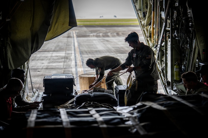 U.S. Coast Guard Petty Officer 2nd Class Chaz Russell and Petty Officer 3rd Class Antony Stark, aviation maintenance technicians assigned to Coast Guard Air Station Barbers Point in Kapolei, Hawaii, secure equipment and supplies on board an HC-130 Hercules airplane at the Antonio B. Won Pat International Airport in Tamuning, Guam, April 17, 2026. Coast Guard transported personnel with FEMA, the U.S. Army Corps of Engineers, the Department of Public Health and Social Services, and the Department of War to Saipan in support of recovery efforts following Typhoon Sinlaku. (U.S. Coast Guard photo by Chief Petty Officer Corinne Zilnicki)