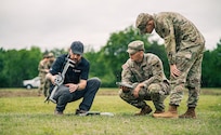 Two Oklahoma National Guardsmen along with a Skydio National Security Field Representative, one of many partners in drone innovation, prepare a drone for takeoff during Exercise Lightning Strike at Camp Gruber Training Center, Oklahoma, April 15, 2026. The Oklahoma National Guard, in partnership with Oklahoma Office of Emergency Management, hosted the domestic exercise based on a notional EF5 tornado. At the center of the exercise is the integration of uncrewed aircraft systems (UAS) across various scenarios, enabling real-time data sharing, improved situational awareness and more effective coordination among participating agencies. Exercise Lightning Strike brings together a wide range of agencies to operate within a shared framework, reinforcing the Guard’s role in supporting civil authorities during domestic incidents and natural disasters.(Oklahoma National Guard photo by Sgt. Anthony Ackah-Mensah)