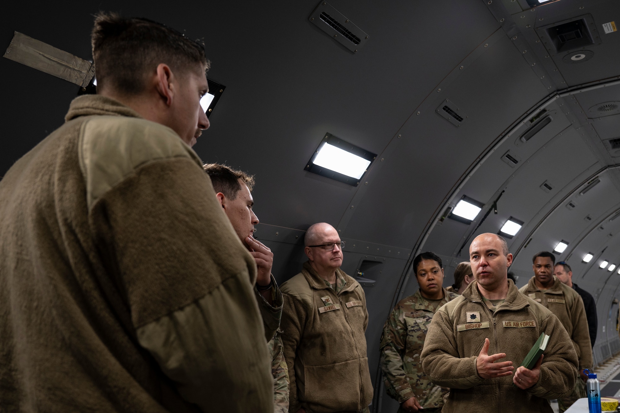 U.S. Air Force Lt. Col. Benjamin Bishop, Air Mobility Command Surgeon General’s deputy command bioenvironmental engineer, answers questions from 605th Aircraft Maintenance Squadron members during Radiant Falcon training at Joint Base McGuire-Dix-Lakehurst, N.J., March 26, 2026.
