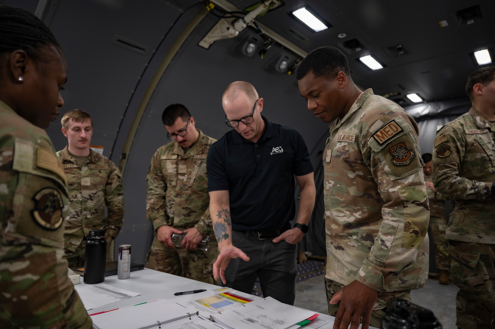 Jason Braun (center), Alliance Solutions Group contractor, guides U.S. Air Force bioenvironmental engineering technicians assigned to the 87th Operational Medical Readiness Squadron through Radiant Falcon training at Joint Base McGuire-Dix-Lakehurst, N.J., March 26, 2026.