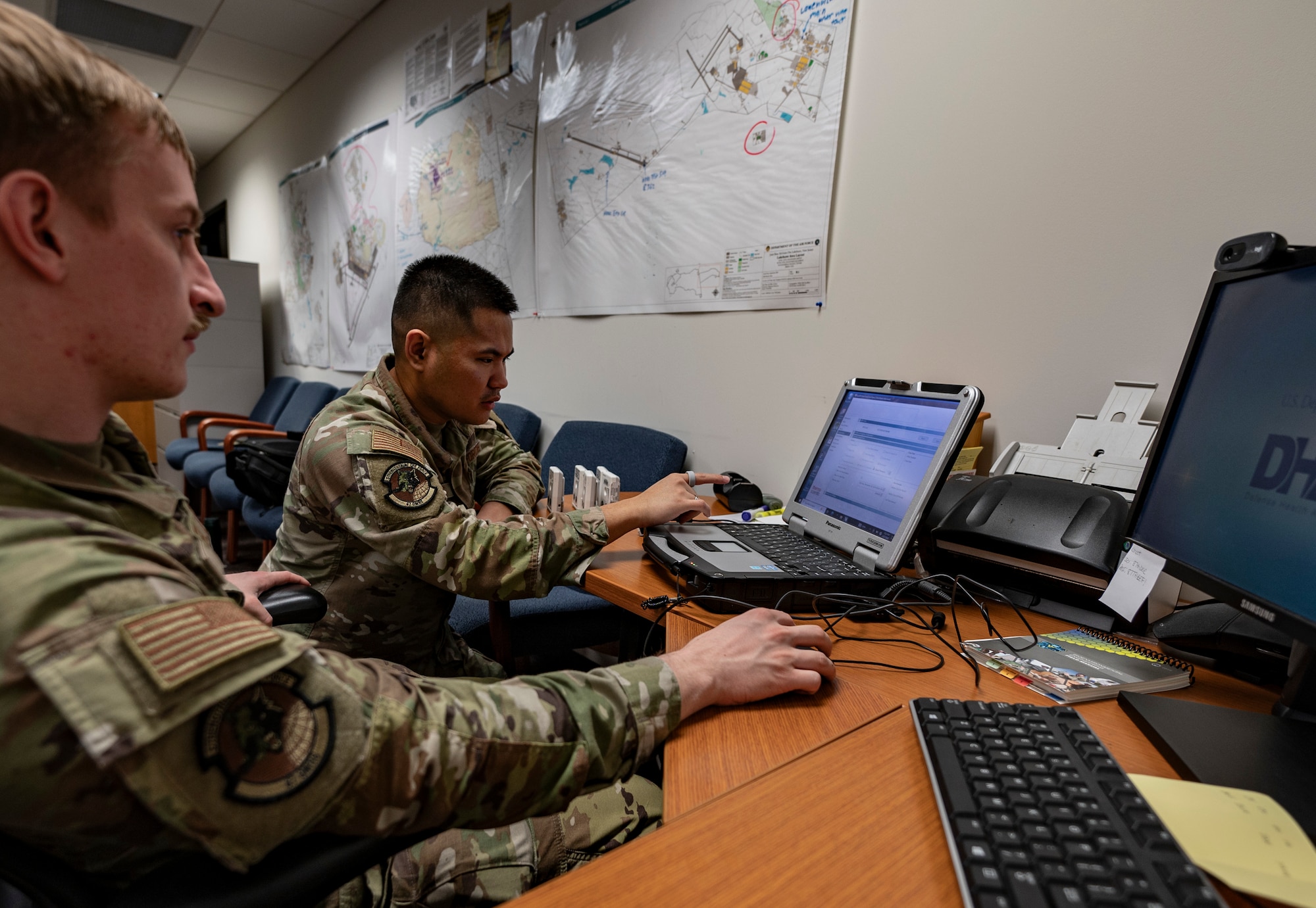U.S. Air Force Airman Jake Kelley, 87th Operational Medical Readiness Squadron bioenvironmental engineering technician, and Staff Sgt. Nino Dalusong, 87th OMRS noncommissioned officer in charge of readiness and operations, use an electronic personal dosimeter reader to transfer simulated data to a laptop during Radiant Falcon training at Joint Base McGuire-Dix-Lakehurst, N.J., March 27, 2026.