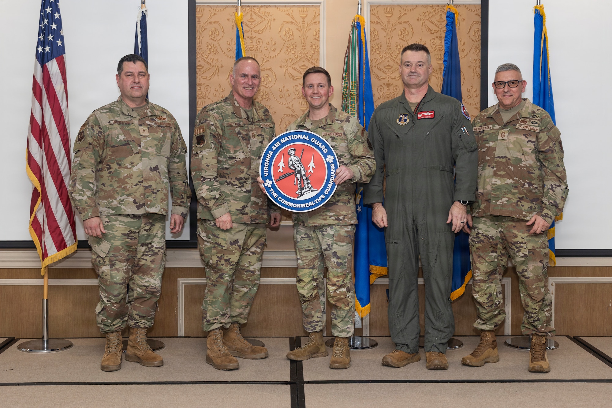Master Sgt. Andrew Bugg, center, VaANG Recruiting and Retention Flight senior enlisted leader, accepts the National Guard Bureau 2025 Recruiting Flight Chief of the Year award
