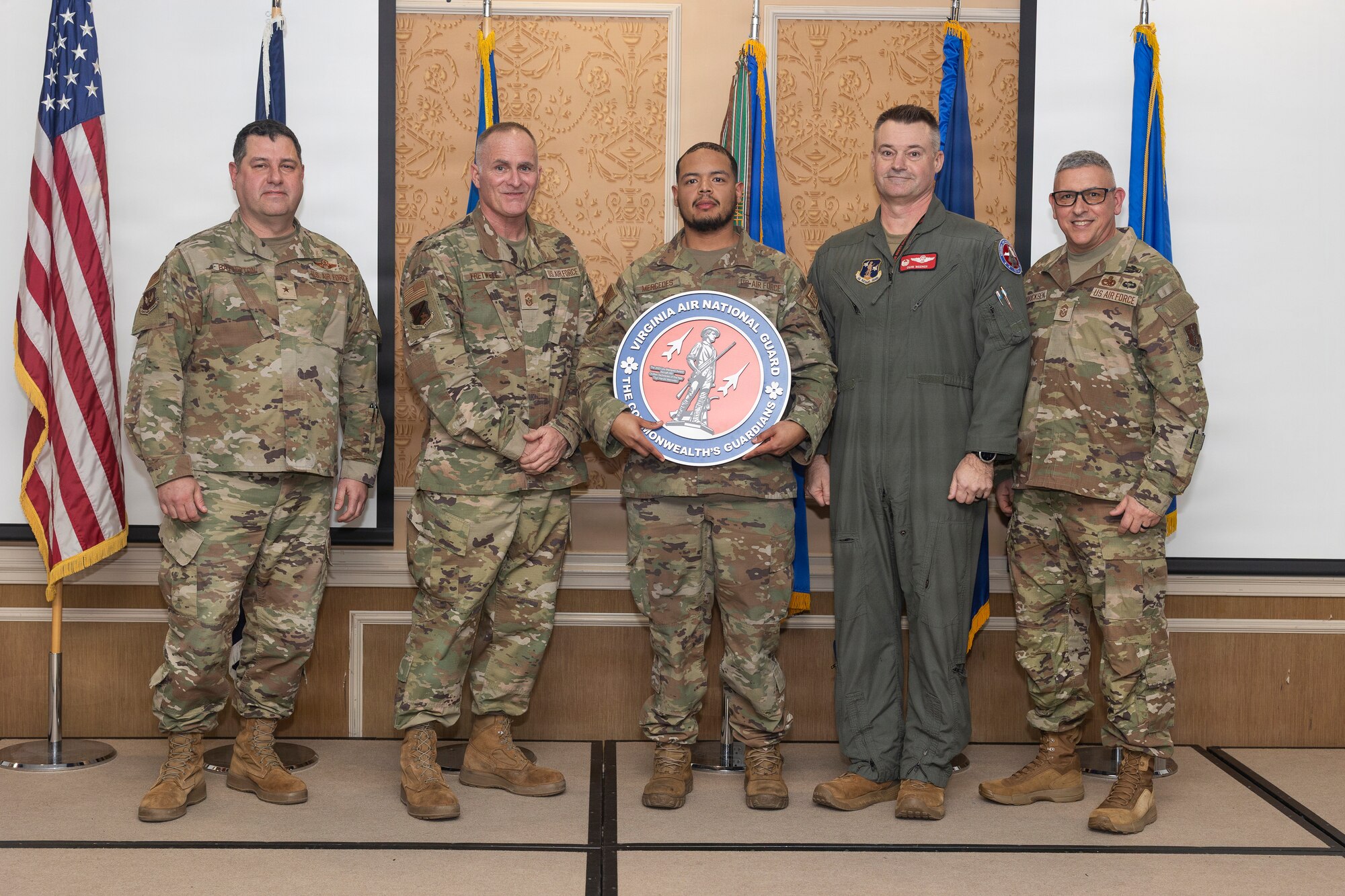 Staff Sgt. Harold Mercedes, center, 192nd Aircraft Maintenance Squadron, accepts the National Guard Bureau Lt. Gen. Leo Marquez Award for the Aircraft Maintenance Civilian Technician of the Year
