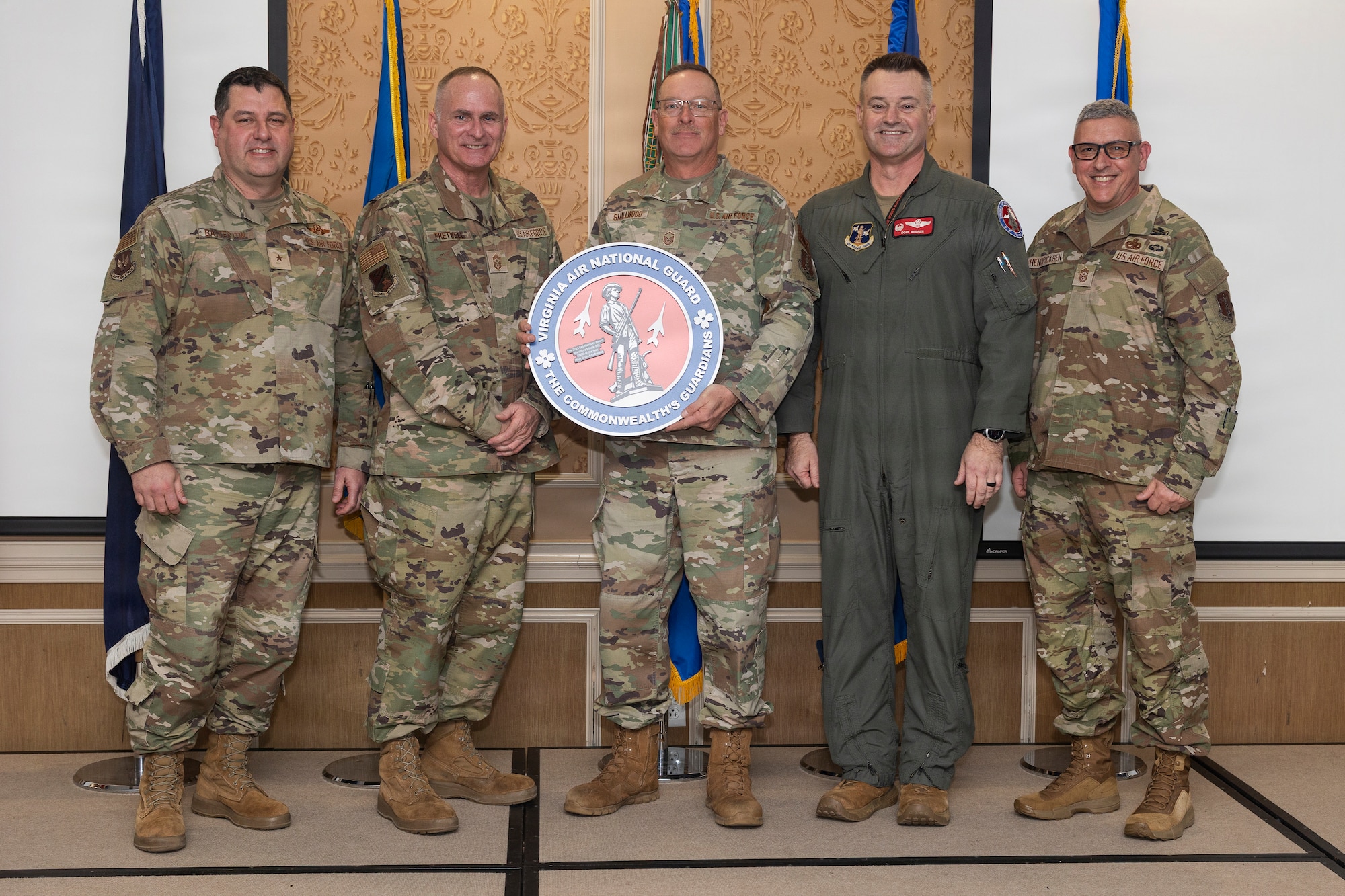 Master Sgt. Orien Smallwood, center, 192nd Maintenance Squadron, accepts the National Guard Bureau Lt. Gen. Leo Marquez Award for the Munitions Missile Maintenance Manager of the Year.