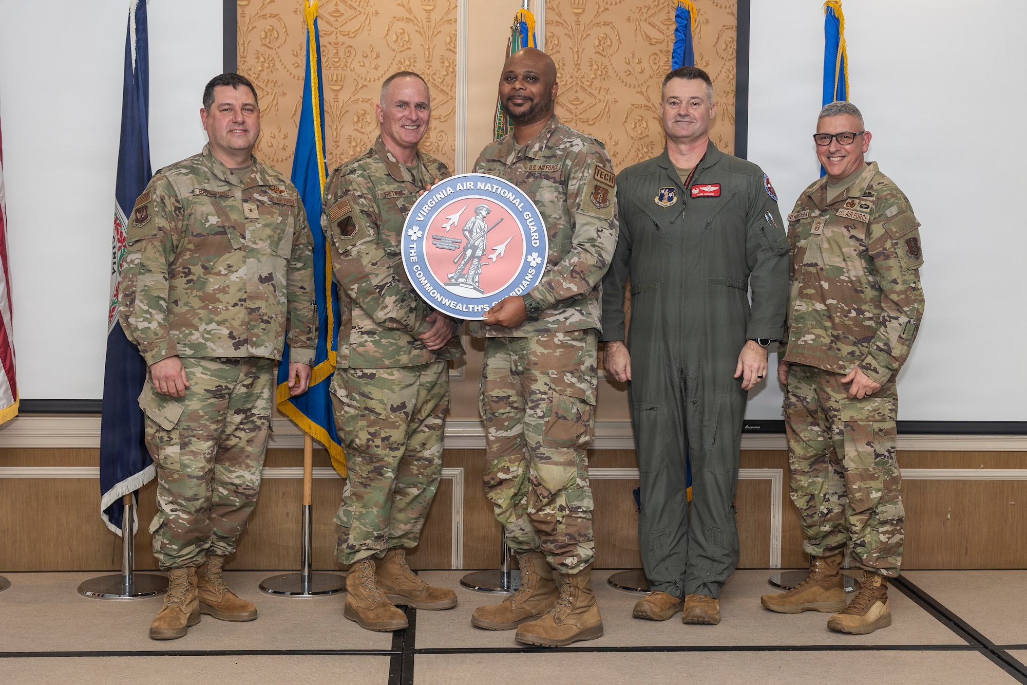 Master Sgt. Zachary Pace, center, 192nd Aircraft Maintenance Squadron, accepts the National Guard Bureau Lt. Gen. Leo Marquez Award for the Aircraft Maintenance Civilian Manager of the Year