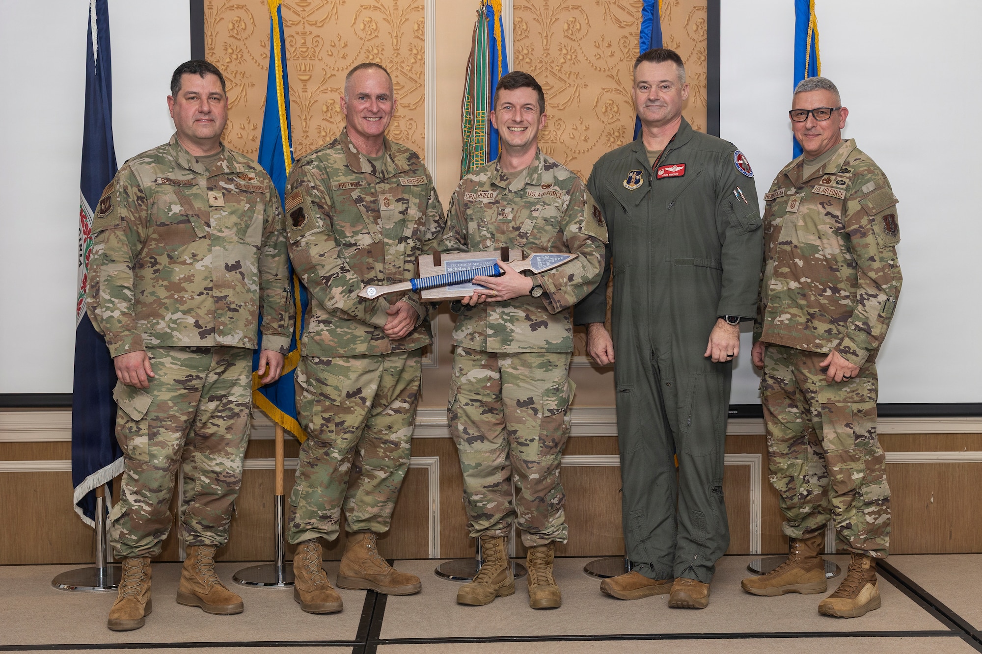 Tech. Sgt. Nicholas Crutchfield, center, accepts the 2025 192nd Wing Top III’s Tip of the Spear Award