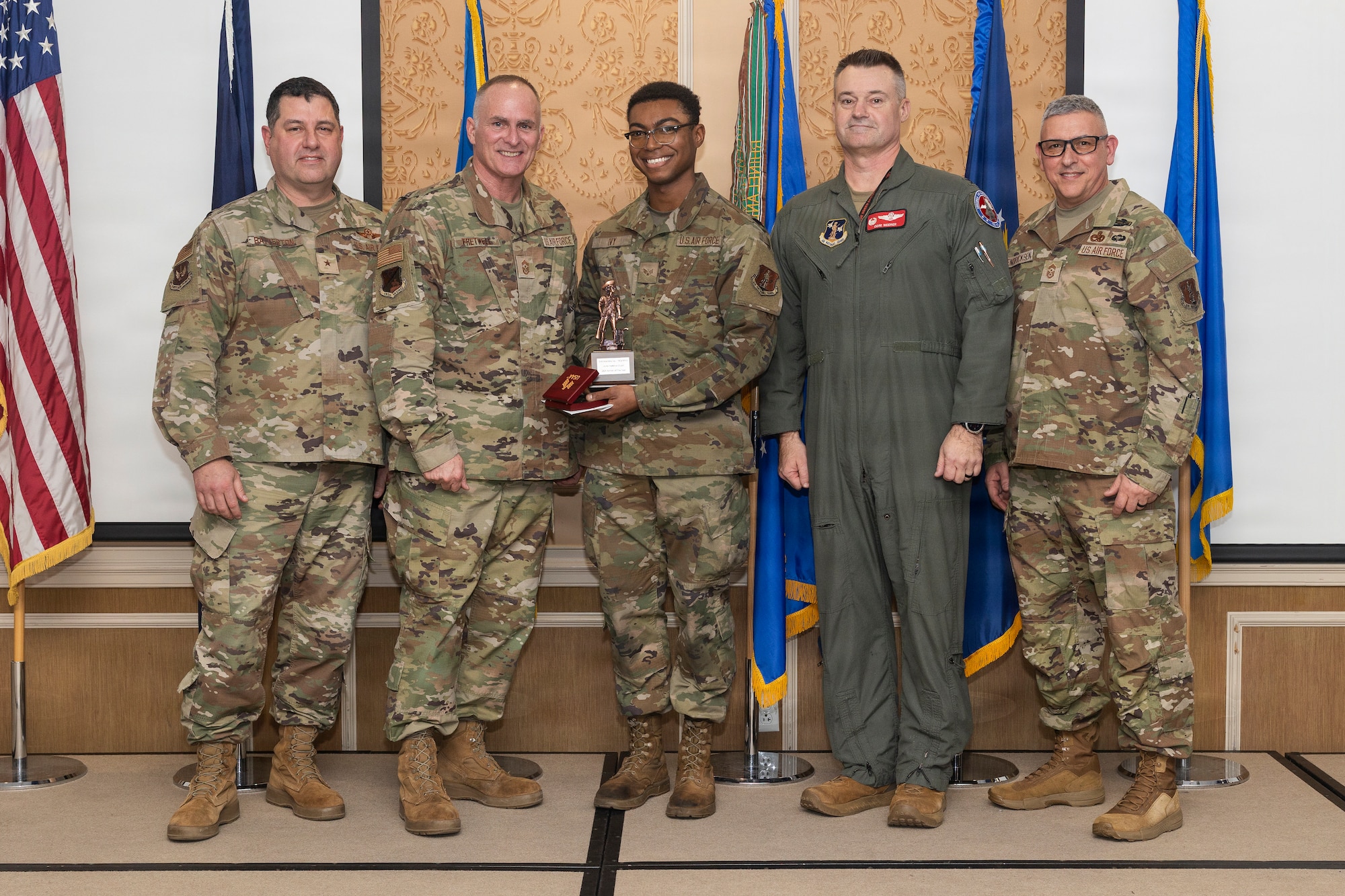 Senior Airman Valentino Ivy, center, 192nd Maintenance Group, accepts the 2026 Virginia Air National Guard Overall Outstanding Airman of the Year Award