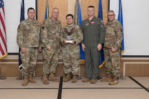 Tech. Sgt. John Willman, center, 192nd Mission Support Group, accepts the 2026 Virginia Air National Guard Guardsman of the Year Award