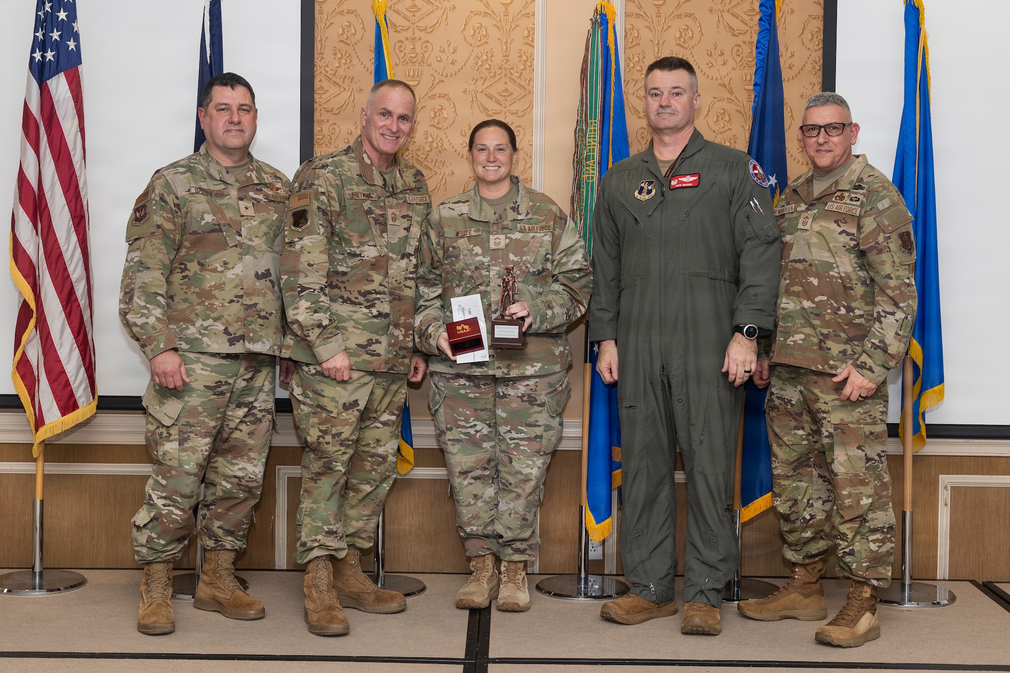 Senior Master Sgt. Kerri White, center, 192nd Maintenance Group, accepts the 2026 Virginia Air National Guard Overall Outstanding Senior Non-Commissioned Officer of the Year Award