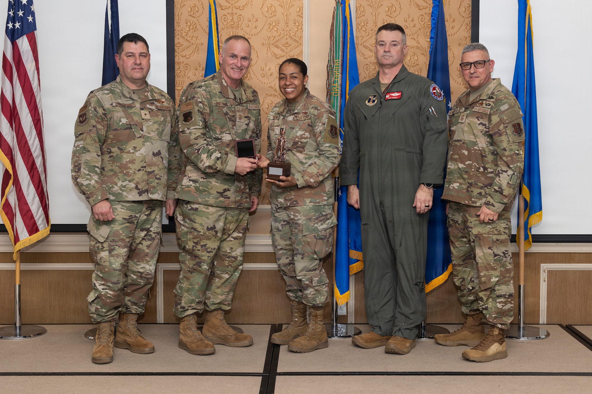 Capt. Darshele Green, center, 192nd Maintenance Group, accepts the 2026 Virginia Air National Guard Outstanding Company Grade Officer of the Year Award