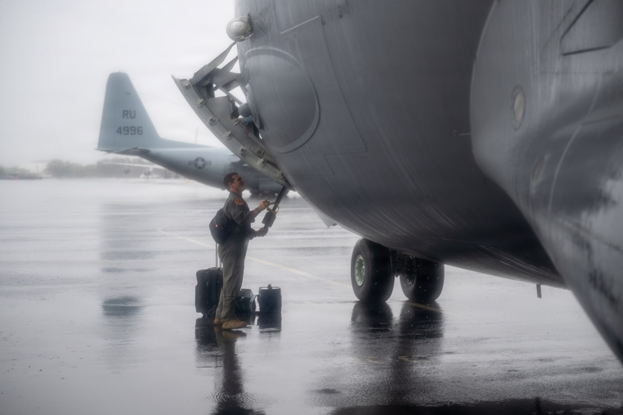 U.S. Air Force Lt. Col. Skip Saito, 204th Airlift Squadron commander, opens the door to a C-17 Globemaster III.
