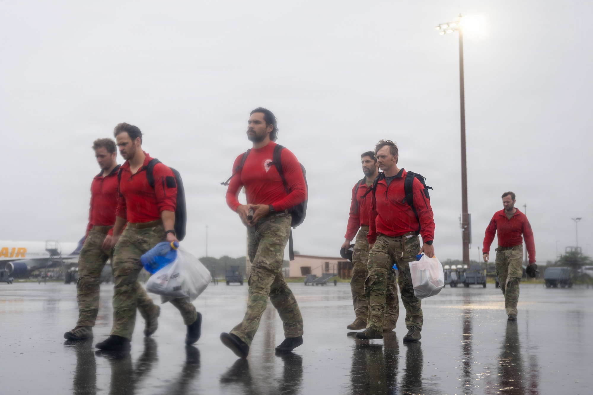 U.S. Air Force pararescuemen walk to an aircraft.