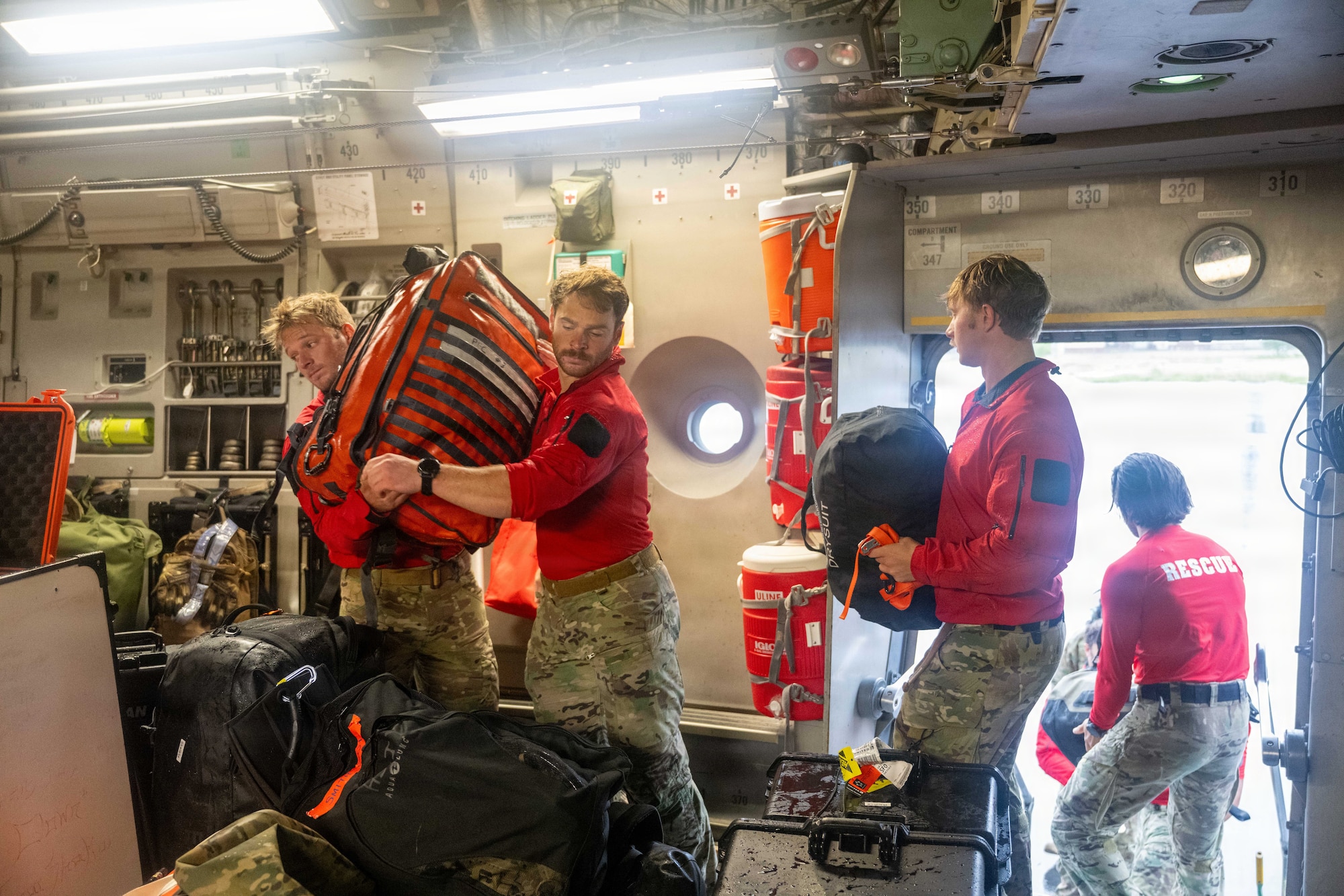 U.S. Air Force pararescuemen load their gear onto a C-17 Globemaster III.