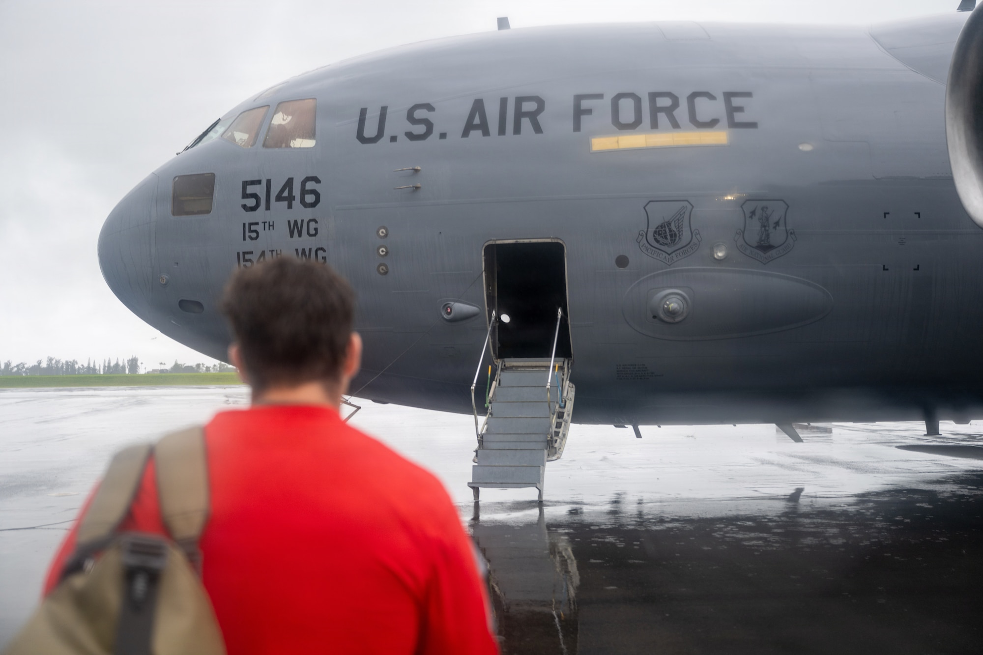 A U.S. Air Force pararescueman walks to an aircraft.