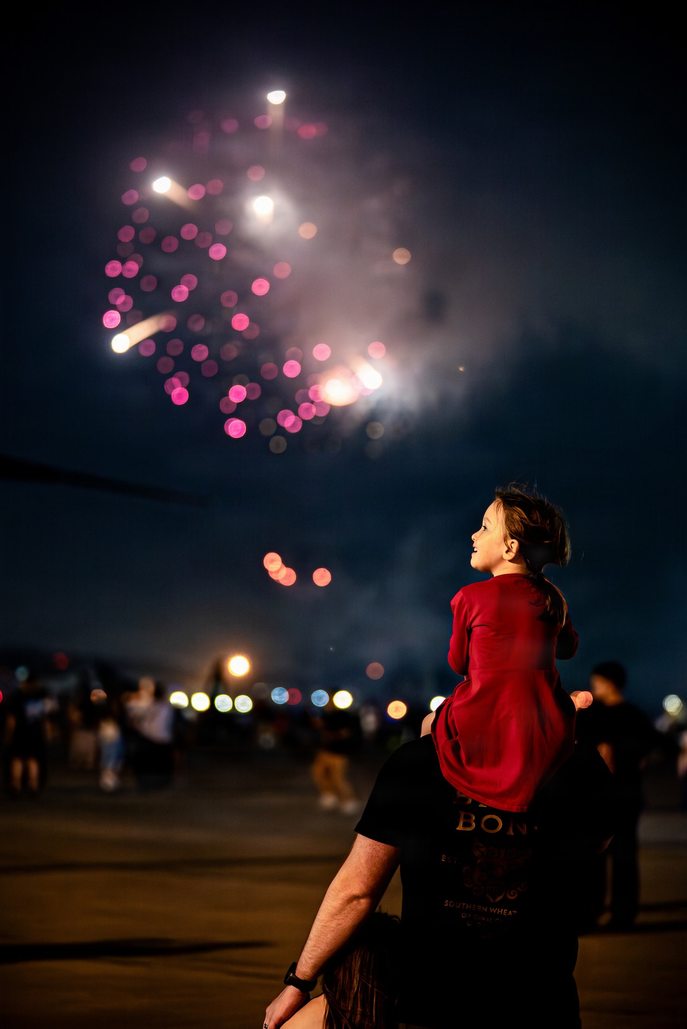 Festival attendees watch a fireworks display during America Fest 2026 at Kadena Air Base, Japan.