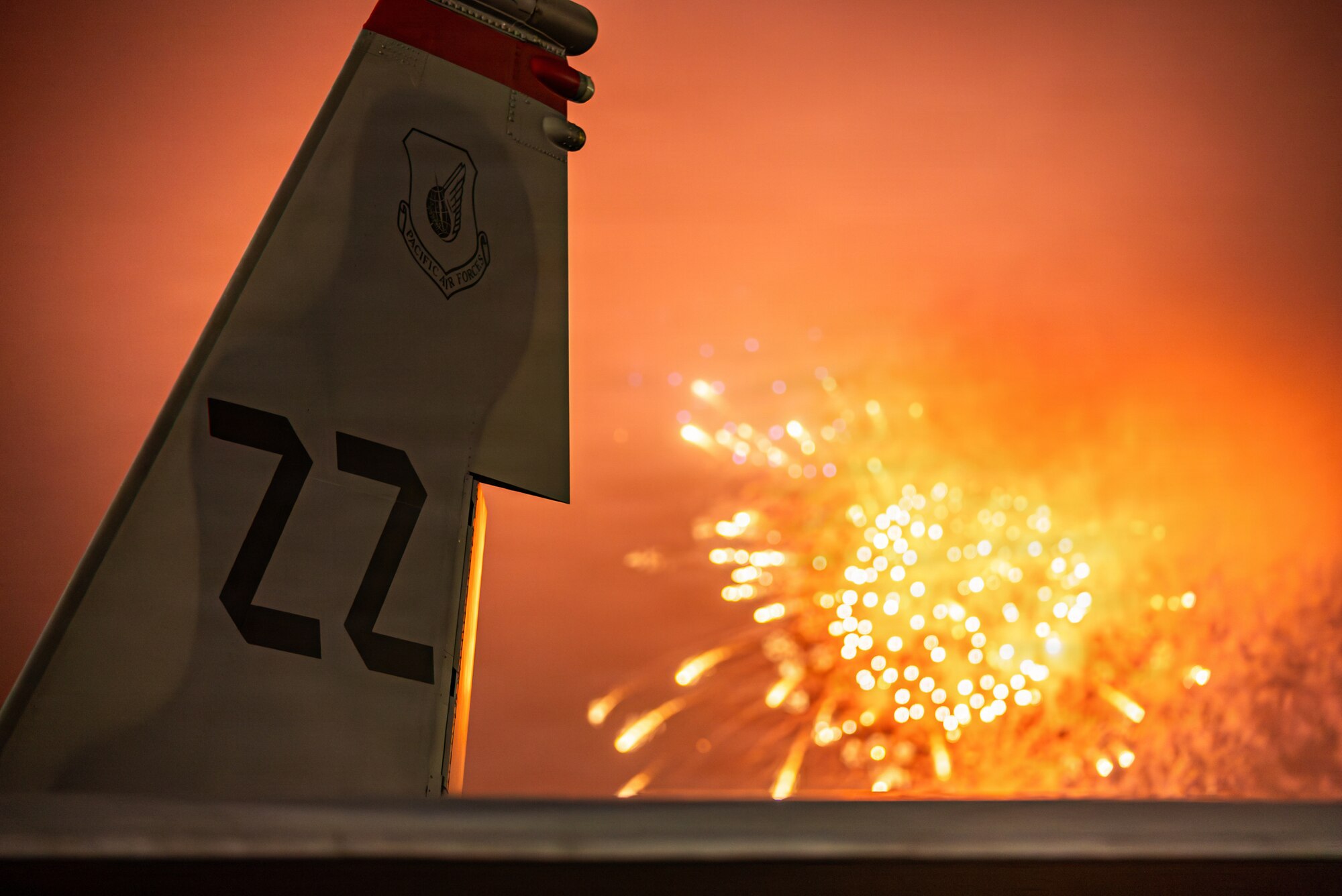 A U.S. Air Force F-15C Eagle tail is displayed as a fireworks presentation closes out day one of America Fest 2026 at Kadena Air Base, Japan.