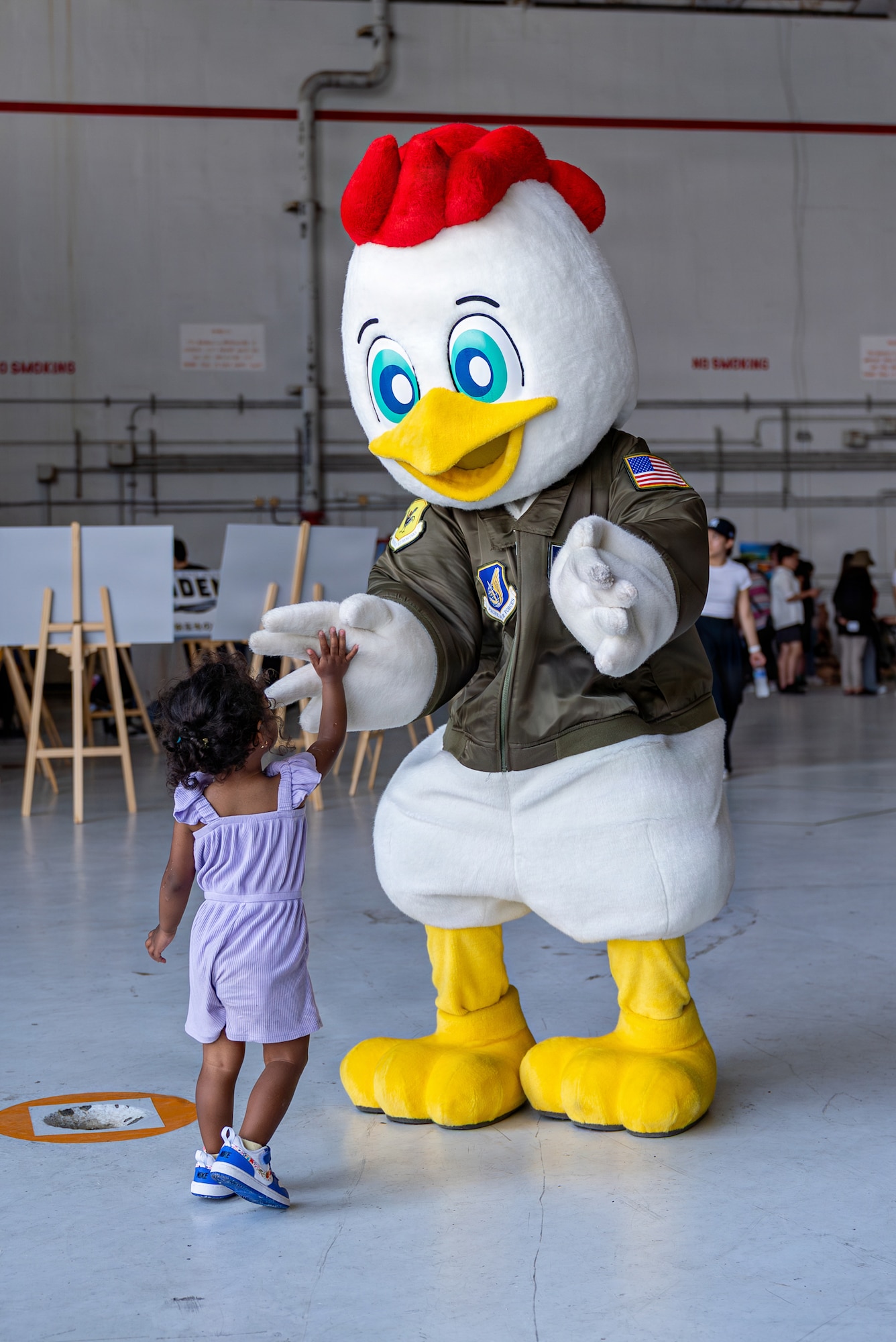 A festival attendee greets Kappy, the 18th Wing’s mascot, during America Fest 2026 at Kadena Air Base, Japan.