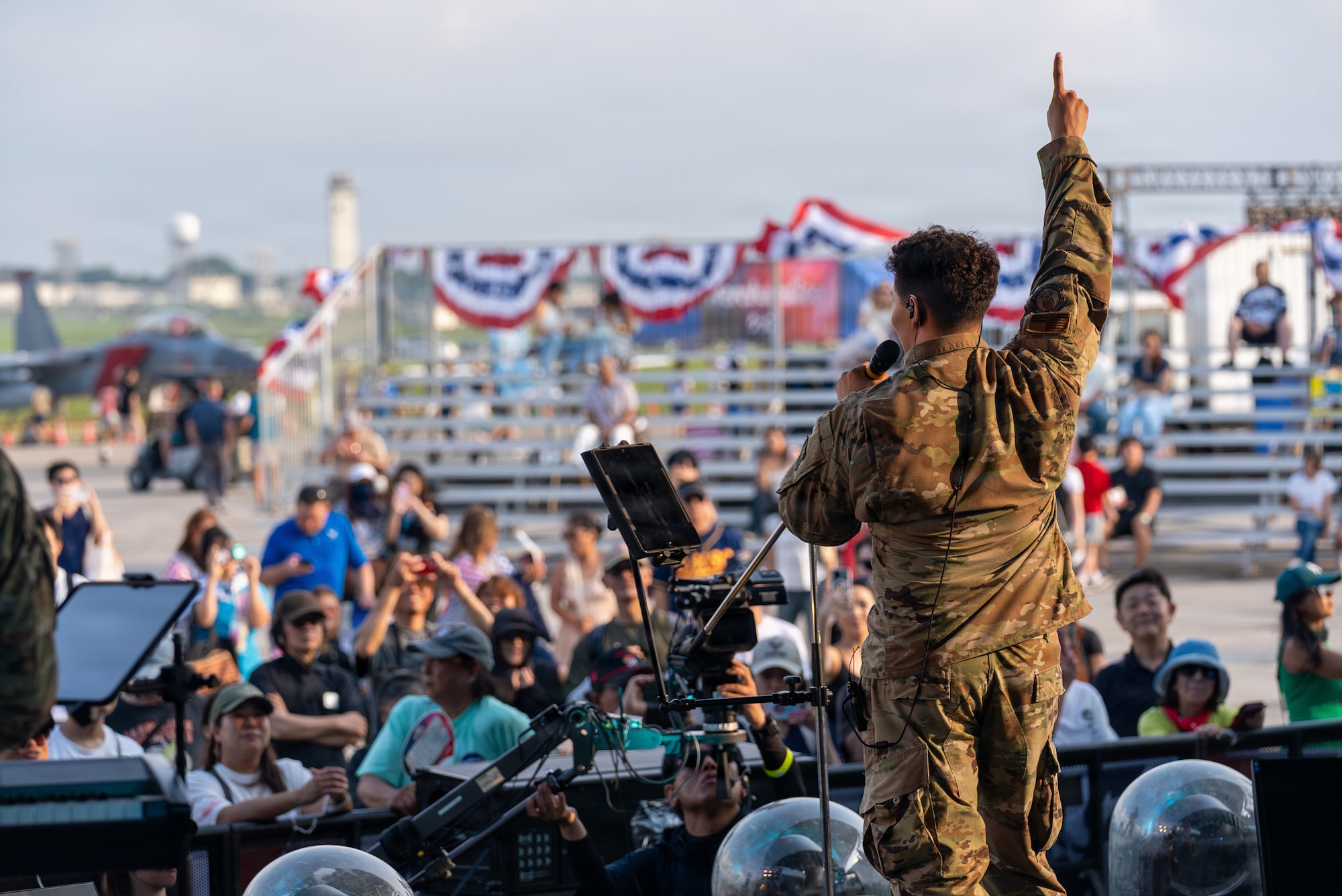 U.S. Air Force Senior Airman Keegan Bushouer, U.S. Air Force Band of the Pacific vocalist, performs during America Fest 2026 at Kadena Air Base, Japan.
