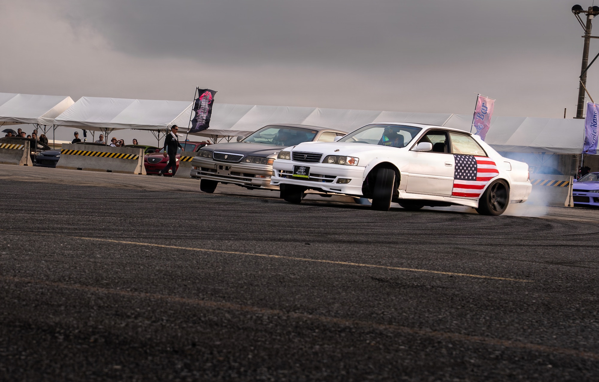 A Drift Fest car participant drifts during America Fest 2026, celebrating the theme, “Stars, Cars and Guitars,” at Kadena Air Base, Japan.