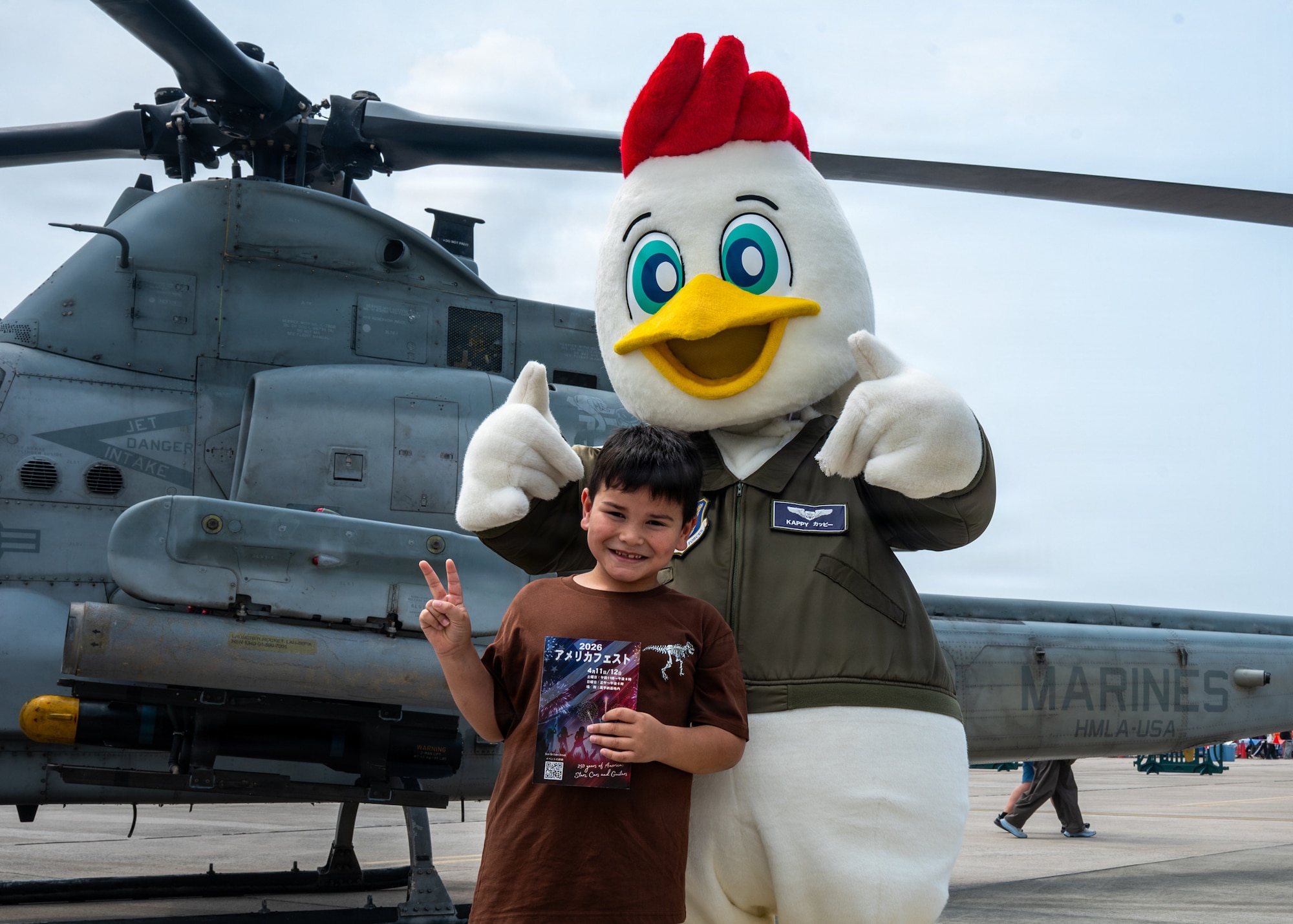 A festival attendee poses for a photo with Kappy, the 18th Wing’s mascot, during America Fest 2026 at Kadena Air Base, Japan.
