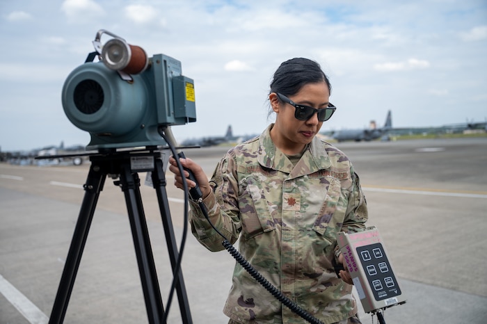 An Airman measures simulated radiation levels.