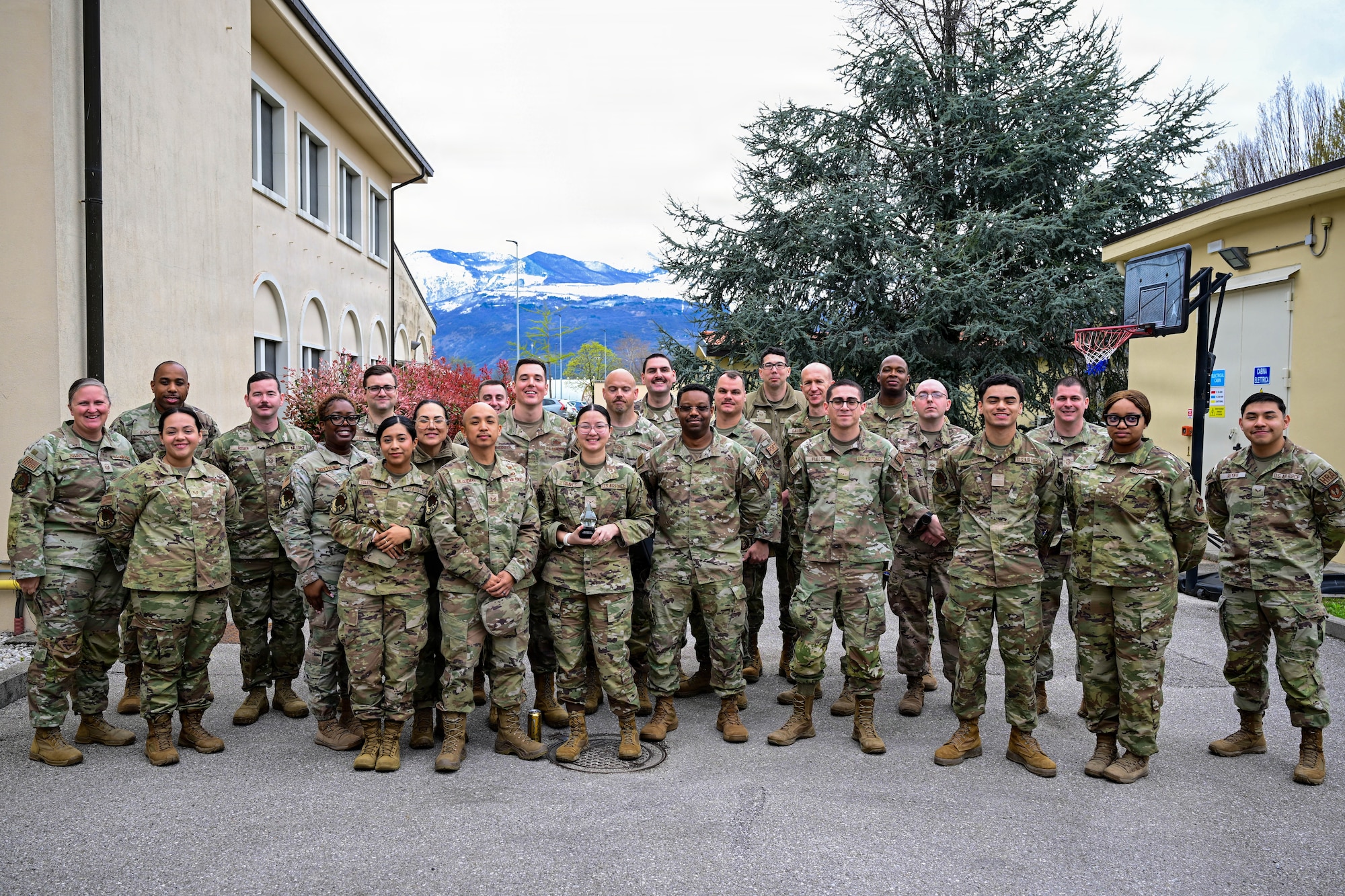 U.S. Air Force Airmen assigned to the 31st Force Support Squadron alongside 31st Fighter Wing first sergeants pose for a group photo to celebrate Airman 1st Class Kyree-Lee Graves, 31st FSS outbound assignments counselor, for receiving the Diamond Sharp Award at Aviano Air Base, Italy, March 26, 2026.
