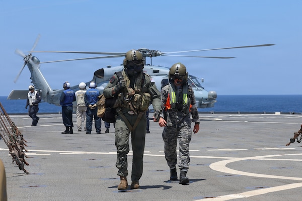 Royal Australian Navy (RAN) Leading Seaman Dominic Turkalj and Leading Seaman Brayden Kennedy, both assigned to RAN Anzac-class frigate HMAS Toowoomba (FFH 156), disembarks RAN MH-60R Sea Hawk on the flight deck of Whidbey Island-class dock landing ship USS Ashland (LSD 48) for a crew exchange during a multilateral exercise with RAN and Royal Canadian Armed Forces in the South China Sea, April 14, 2026.