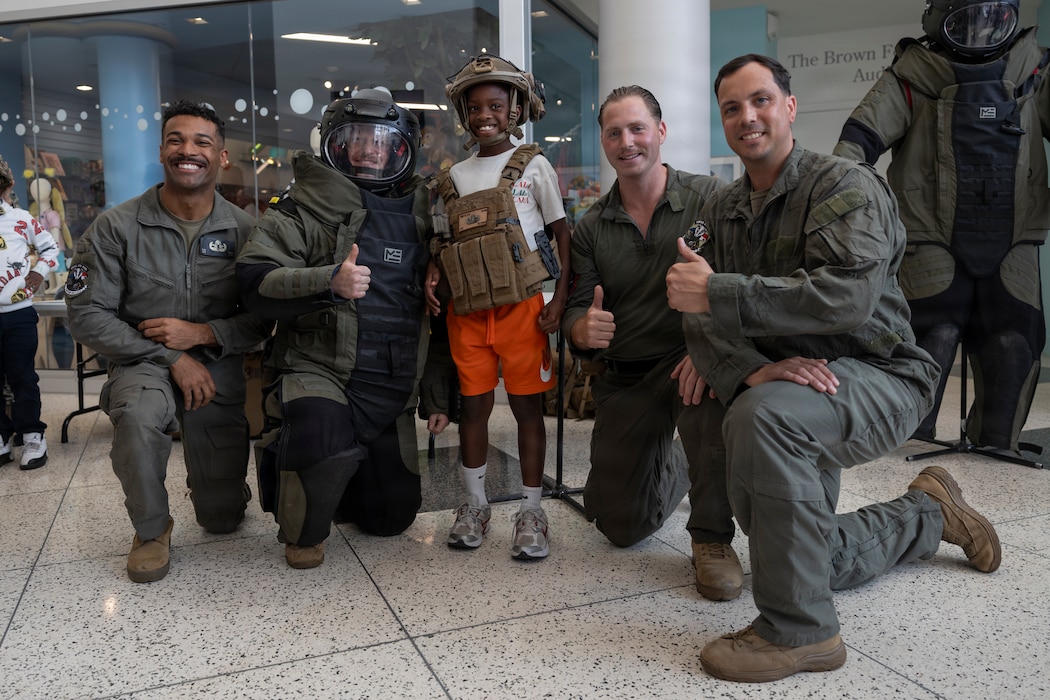 U.S. Marines with 8th Engineer Support Battalion, Combat Logistics Regiment 27, 2nd Marine Logistics Group, pose for a photo with a child at Children’s Museum Houston in Houston, Texas, April 16, 2026. Held in partnership with Freedom 250, the inaugural Fleet Week Houston commemorates the 250-year legacy of America while showcasing its sea service’s cutting-edge technology and the unwavering dedication of our warfighters. (U.S. Marine Corps photo by Lance Cpl. Perri Wood)