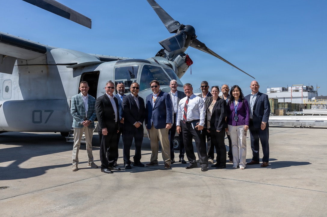 Civilian leaders and business executives of the Marine Corps Senior Executive Forum pose for a photo at Marine Corps Air Station New River, North Carolina, April 15, 2026. The tour gave the Senior Executive staff direct insight into MCAS New Rivers' aviation operations and modernization efforts across Marine Corps Base Camp Lejeune, necessary to maintain a continuous deployment-ready tempo. (U.S. Marine Corps photo by Lance Cpl. Erica S. Padgett)