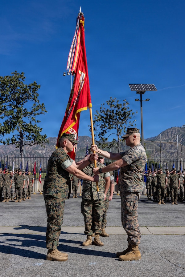 U.S. Marine Corps Lt. Col Michael P. Smith, left, incoming commanding officer of 2nd Battalion, 23rd Marine Regiment, 4th Marine Division, receives the unit colors to Lt. Col. Davis B. Gooding III, right, outgoing commanding officer of 2nd Bn., 23rd Marine Regiment, 4th MARDIV, during a change of command ceremony in Pasadena, Calif., March 14, 2026. During the ceremony, Gooding III relinquished command of the battalion to Smith. The ceremony signified the transfer of accountability, responsibility and authority to new leadership and the continuity of command. (U.S. Marine Corps photo by Lance Cpl. Adrian Estrada)
