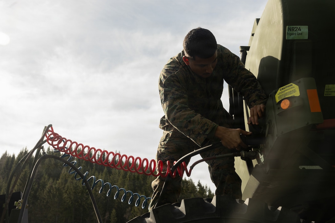 U.S. Marine Corps Cpl. Malachi Maldonado, a motor vehicle operator with Marine Wing Support Squadron 273, Marine Air Control Group 28, 2nd Marine Aircraft Wing, prepares to offload an M970 semi-trailer refueler in Frigaard, Norway, April 8, 2026. Marines prepared and inspected ground and logistical equipment used during exercise Cold Response 26 for cave regeneration operations. A key component of NATO's enhanced vigilance activity Arctic Sentry, exercise Cold Response 26 is a Norwegian-led winter military exercise designed to enhance collective defense capabilities and ensure U.S. readiness to rapidly deploy and seamlessly operate alongside NATO Allies in challenging arctic conditions. Maldonado is a native of Texas. (U.S. Marine Corps photo by Lance Cpl. Franco Lewis)