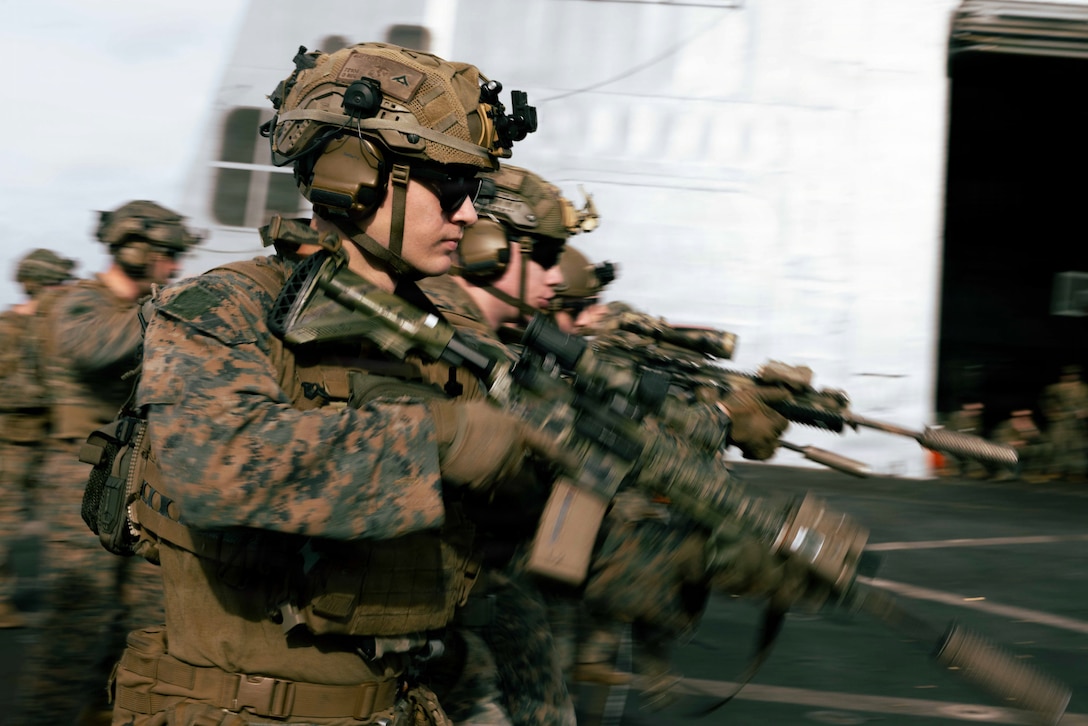 U.S. Marines with Lima Company, Battalion Landing Team 3/6, 22nd Marine Expeditionary Unit (Special Operations Capable), conduct a firing while moving drill during a deck shoot aboard San Antonio-class amphibious transport dock USS San Antonio (LPD 17) while underway in the Caribbean Sea, April 14, 2026. U.S. military forces are deployed to the Caribbean in support of the U.S. Southern Command mission, Department of War-directed operations, and the president’s priorities to disrupt illicit drug trafficking and protect the homeland. (U.S. Marine Corps photo)